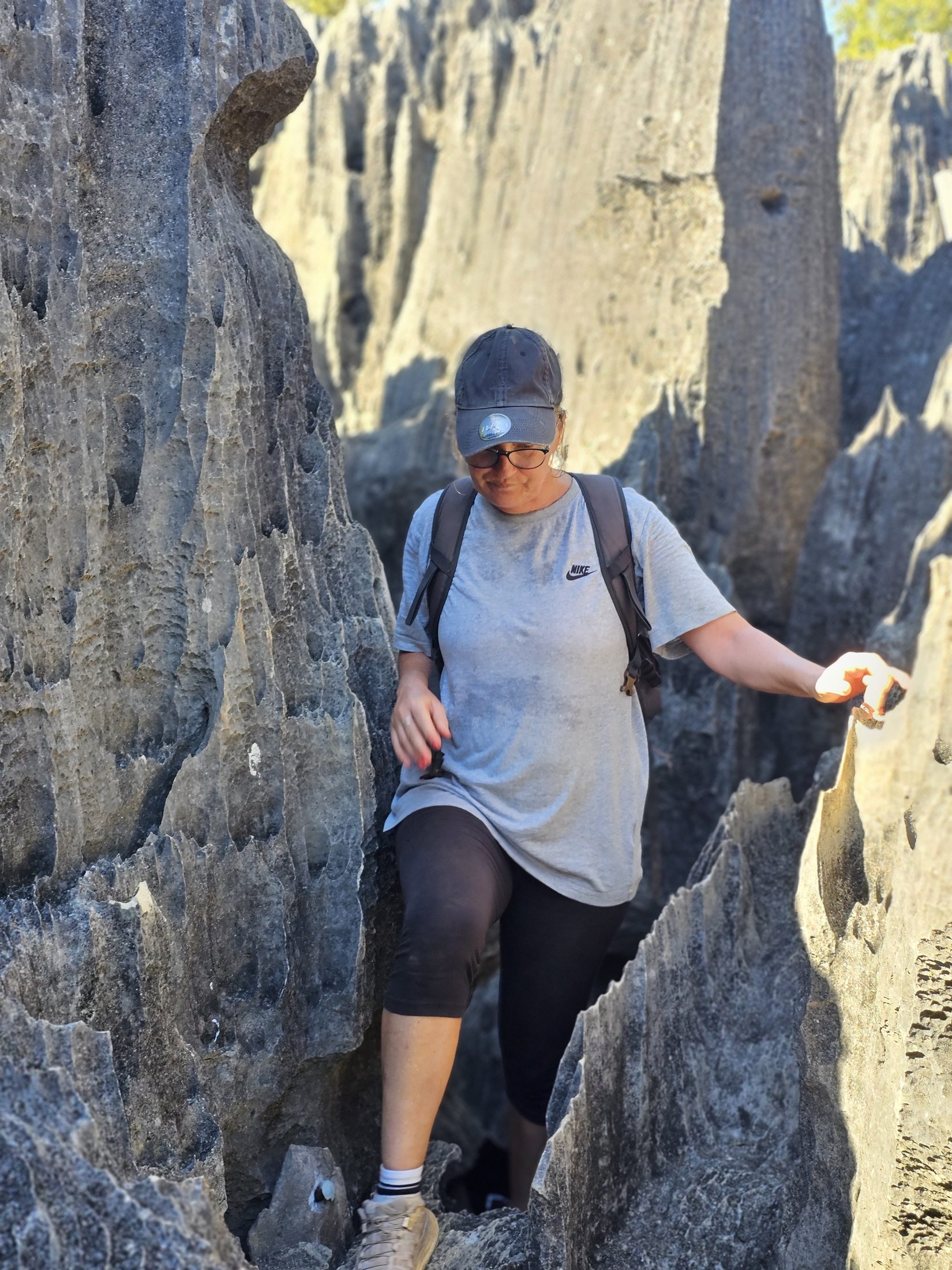 Traveler climbing through Small Tsingy limestone corridors